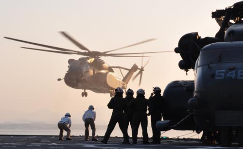 In the Sea of Japan, the day after the tsunami struck, MH-53 helicopters land aboard the amphibious dock landing ship USS Tortuga, which has been deployed to support earthquake and tsunami relief efforts in Japan. Photo: Lt. K. Madison Carter/US Navy.